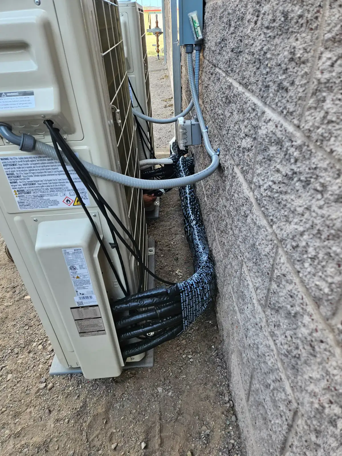 Outdoor mini-split condenser with connected refrigerant lines